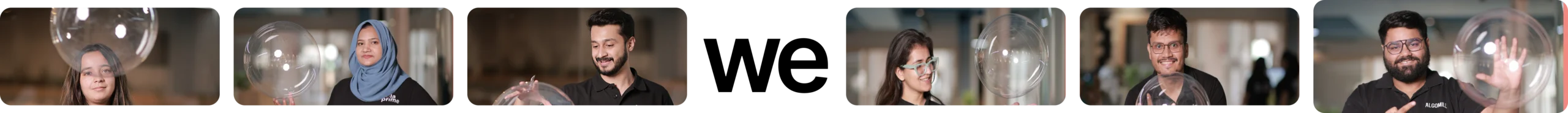 Team members in Hola Prime smiling and playing with transparent bubbles indoors — tech company culture and diversity.