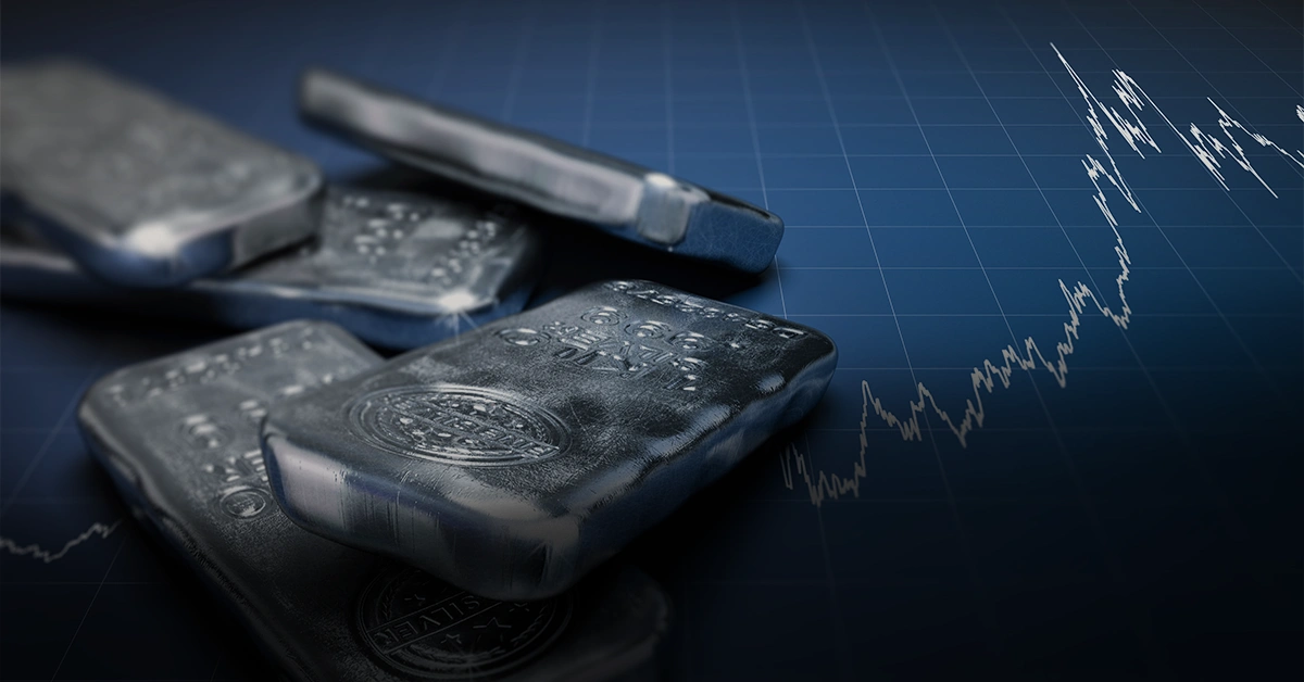 Silver bullion bars on a financial chart background.