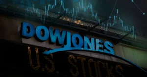 Large blue "Dow Jones" sign above a U.S. stock ticker, with a faint overlay of a Trading candlestick chart .