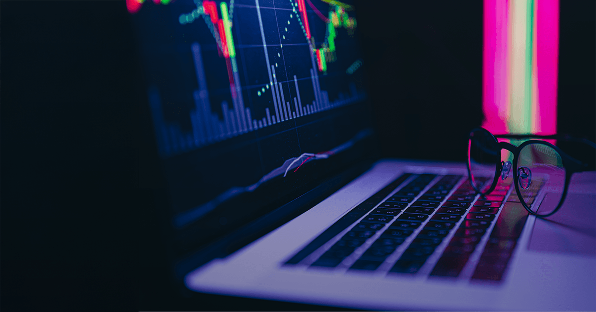 A laptop screen with candlestick chart on display